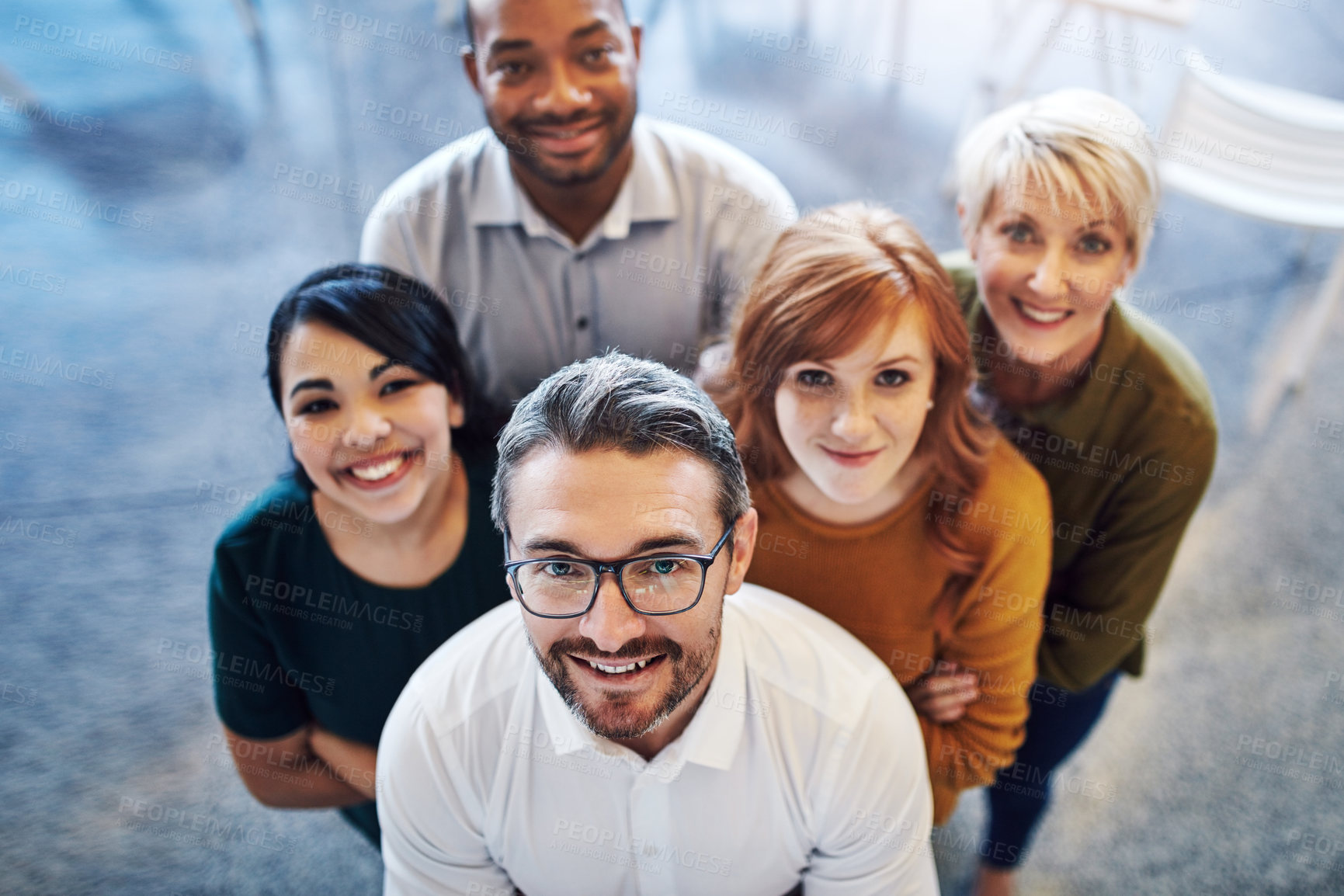 Buy stock photo High angle portrait of a team of colleagues standing together in a modern office