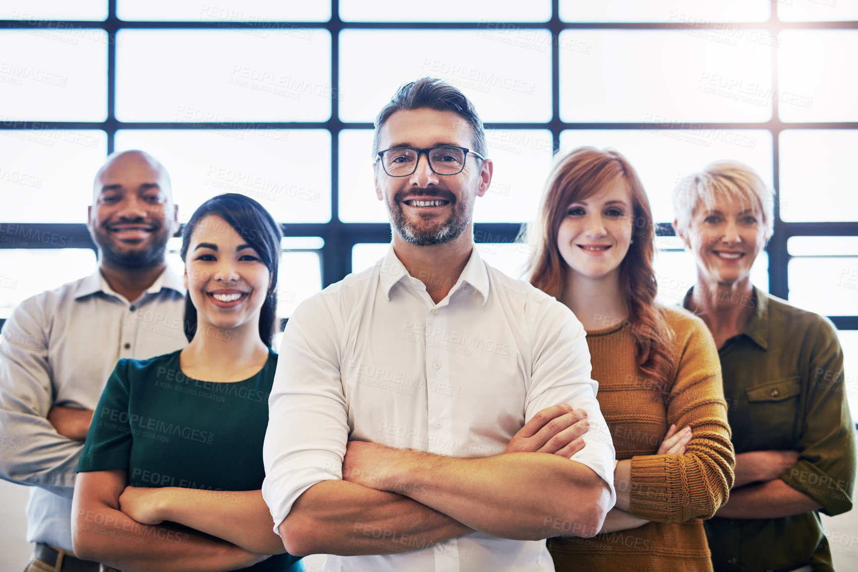 Buy stock photo Smiling group of confident diverse and modern business people, standing, arms crossed with leadership quality. Professional team of work colleagues proud with unity together in modern office 