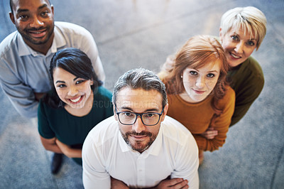 Buy stock photo High angle portrait of a team of colleagues standing together in a modern office
