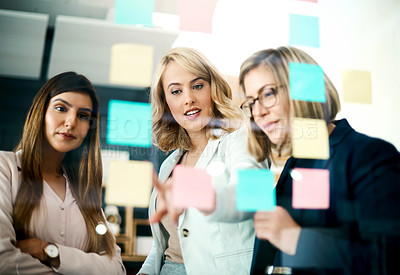 Buy stock photo Women, meeting and brainstorming schedule for planning, problem solving and agenda at window. Employees, teamwork and goals with sticky note for timeline of workflow process, calendar and ideas