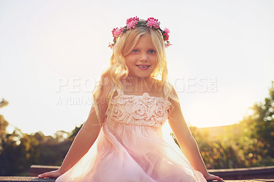 Buy stock photo Shot of a happy little girl looking at the camera while being seated on the edge of a bridge outside in nature