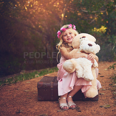 Buy stock photo Shot of a happy little girl sitting and waiting with her teddy bears in the middle of a dirt road