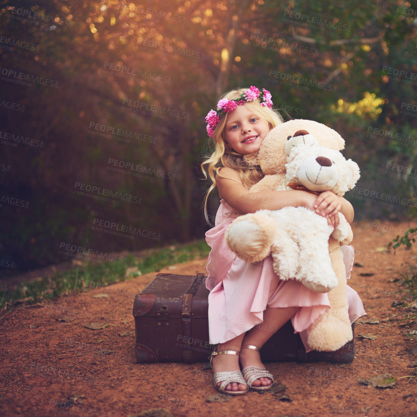 Buy stock photo Happy, teddy bear and portrait of kid in nature for fantasy, imagination or play time in forest. Smile, sweet and cute girl child from Germany with flower crown and plush toy outdoor in woods.