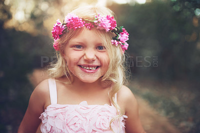 Buy stock photo Shot of a happy little girl looking at the camera and smiling while standing in the middle of a dirt road