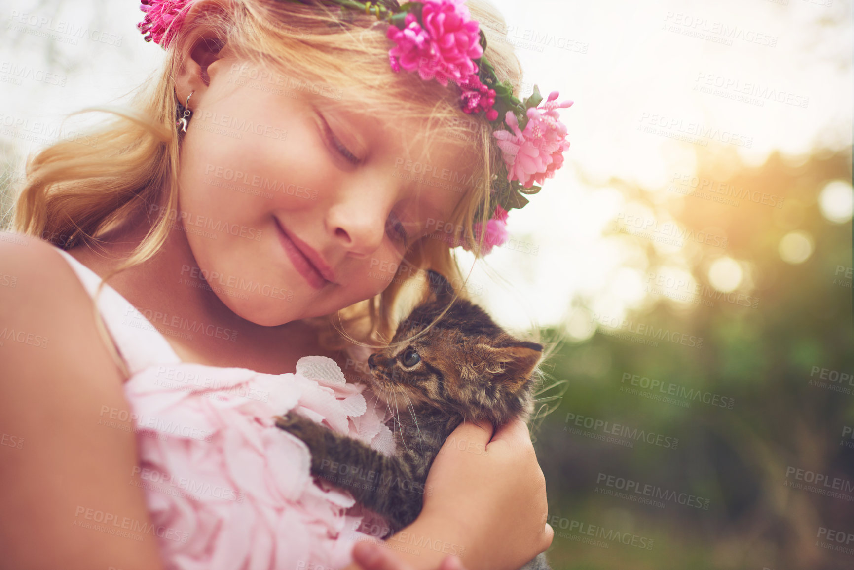 Buy stock photo Girl, happy and outdoor with kitten for love or furry companion for comfort, friendship and growth or development. Kid, flower crown and cute animal in nature with affection, bonding and playing.