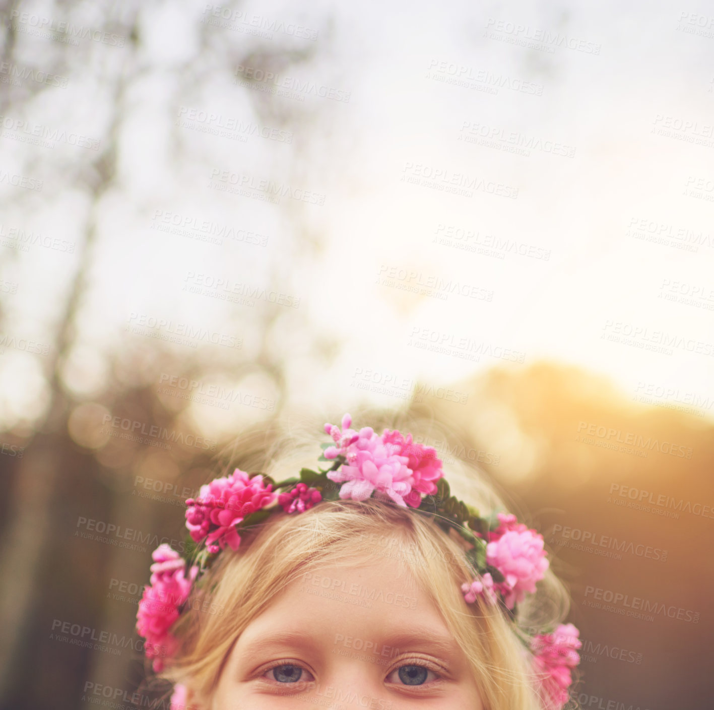 Buy stock photo Shot of a little girl's eyes looking at the camera and hiding while standing outside in nature