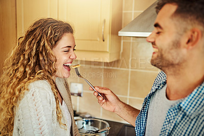 Buy stock photo Cropped shot of a young man feeding his girlfriend pancakes