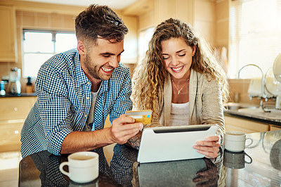 Buy stock photo Cropped shot of a young couple using a digital tablet together at home