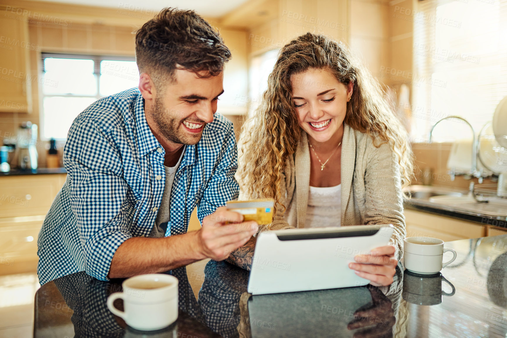 Buy stock photo Cropped shot of a young couple using a digital tablet together at home
