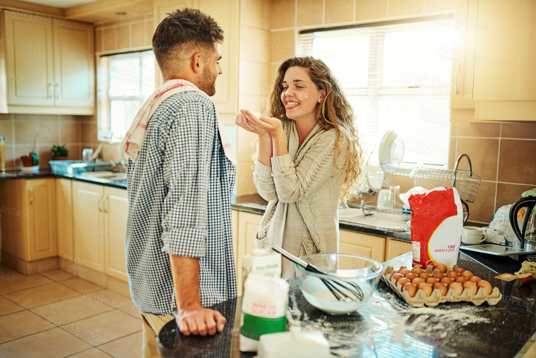 Buy stock photo Shot of a loving couple baking in their kitchen