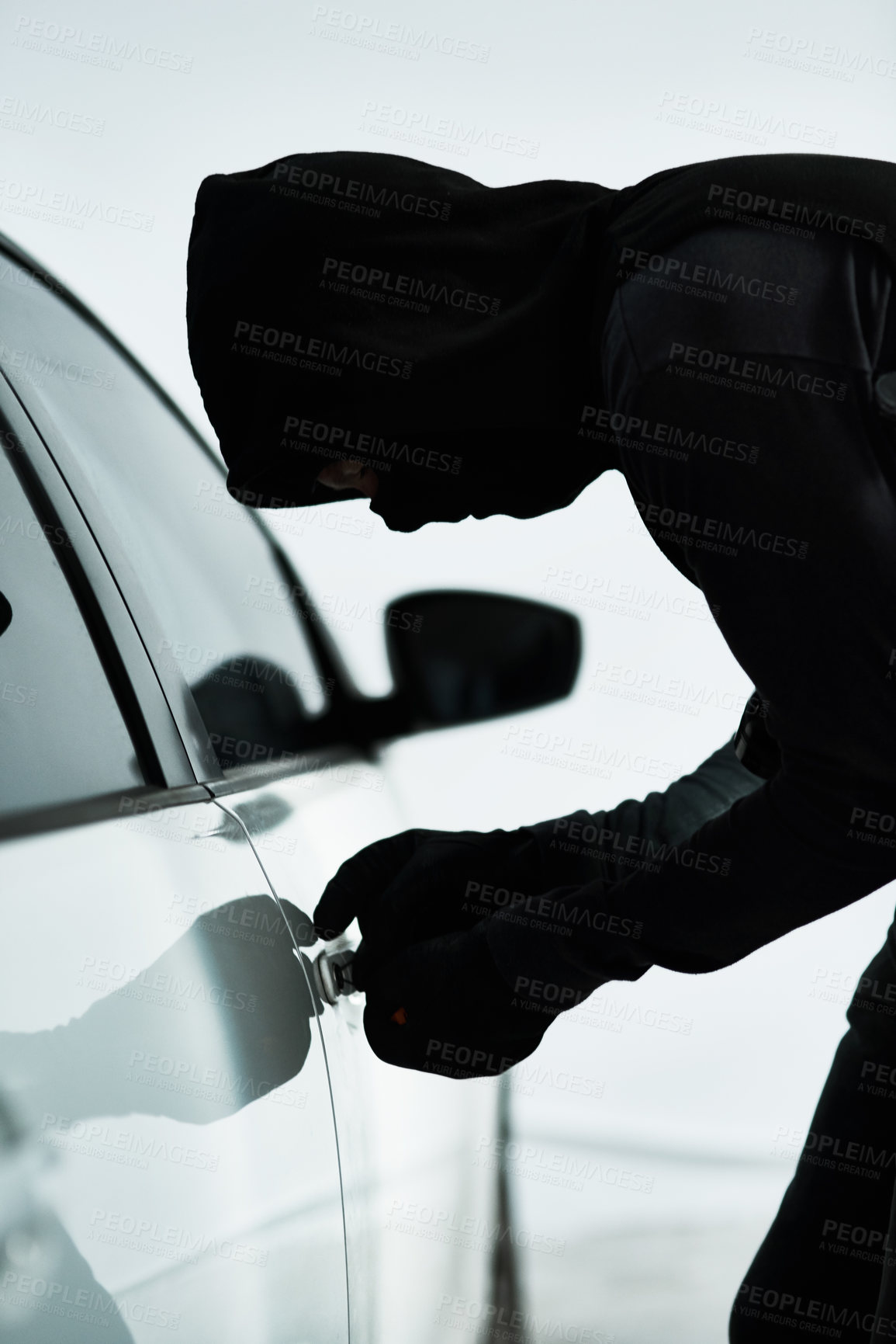 Buy stock photo Man, car and steal with theft tool, picking lock and illicit behaviour or automobile jacking. Criminal, makeshift key and hooded offender or disabling vehicle alarm, parking lot and illegal burglary