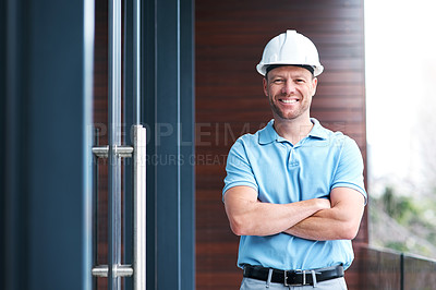 Buy stock photo Portrait of a cheerful engineer posing with his arms folded outside a building