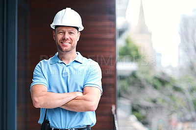Buy stock photo Portrait of a cheerful engineer posing with his arms folded outside a building
