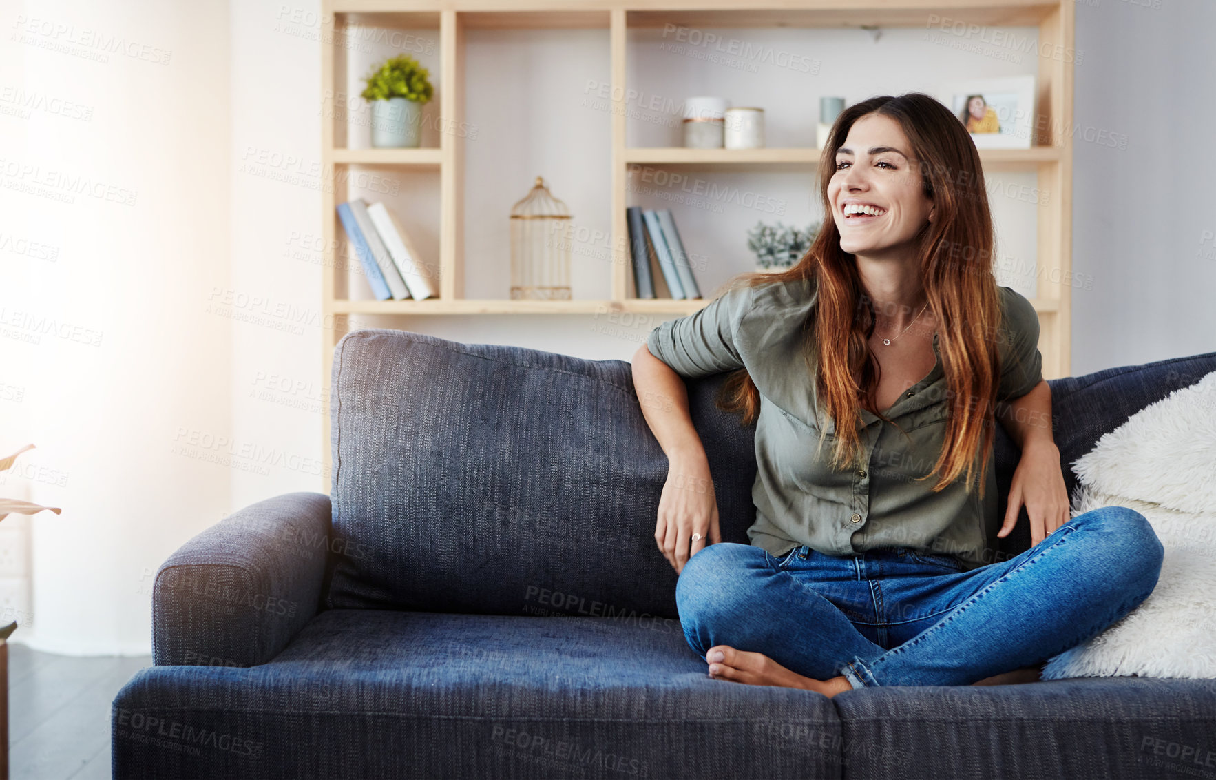Buy stock photo Shot of a beautiful young woman relaxing in the sofa at home