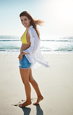 Buy stock photo Shot of a beautiful young woman enjoying her day at the beach