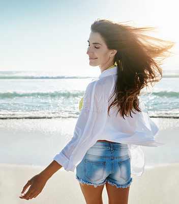 Buy stock photo Shot of a beautiful young woman enjoying her day at the beach