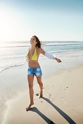 Buy stock photo Shot of a beautiful young woman enjoying her day at the beach