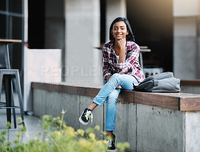 Buy stock photo Full length portrait of an attractive young female student sitting outside on campus