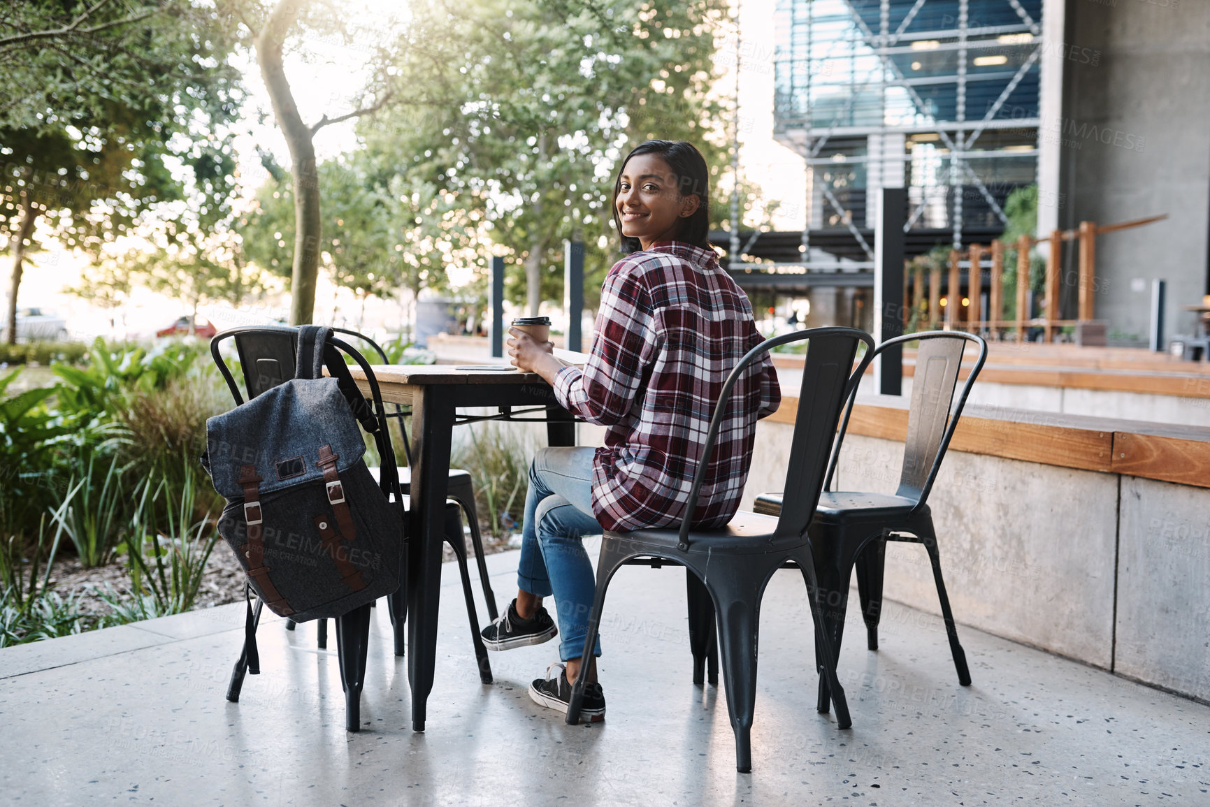 Buy stock photo Woman, portrait and student at university cafe, outdoor studying and espresso for energy at college. Female person, books and campus coffee shop for research on course assignment, India and education