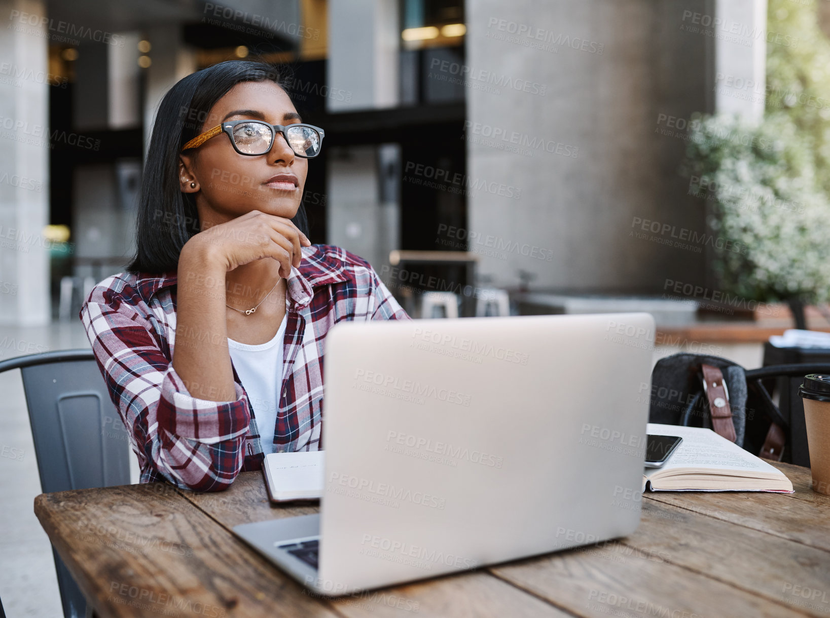 Buy stock photo Student, woman and thinking in cafe, laptop and serious with notebook, table and practice for college. University, digital and person in coffee shop, learning and planning for exam, knowledge or tech