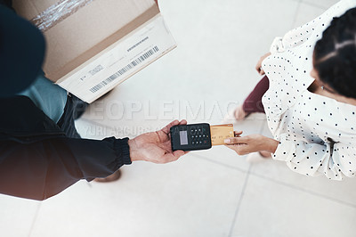 Buy stock photo High angle shot of an unrecognizable delivery man receiving payment from a female customer for her order