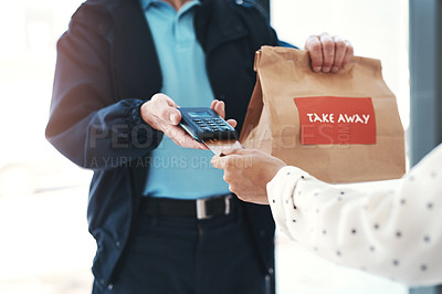 Buy stock photo Shot of an unrecognizable delivery man receiving payment from a female customer for her takeaway