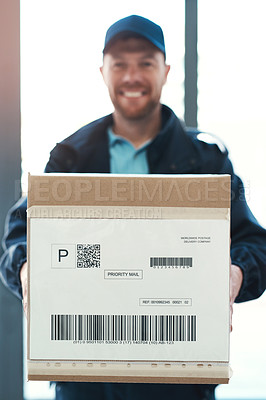 Buy stock photo Portrait of a handsome delivery man waiting in the lobby with a customer's order