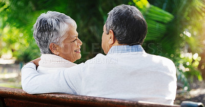 Buy stock photo Senior, happy couple and relax with bench at park for love, embrace or hug in outdoor romance. Rear view of elderly man and woman with smile for retirement, bonding or support outside in nature