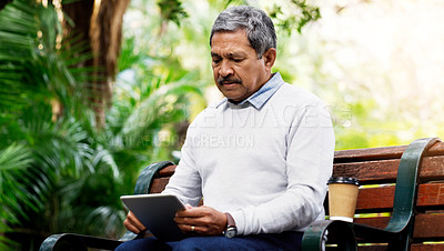 Buy stock photo Park, bench and senior man with tablet for scroll, social media or connection with internet. Relax, coffee and mature person in garden with digital app for reading, ebook or online communication.