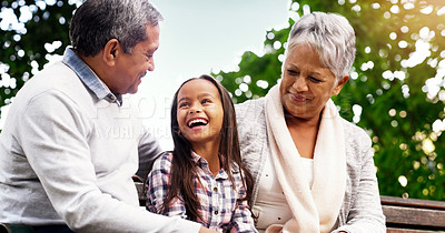 Buy stock photo Park, bench and happy grandparents with child, smile and bonding on outdoor adventure together. Old man, senior woman and girl in backyard with love, laughing and family fun in nature with grandchild