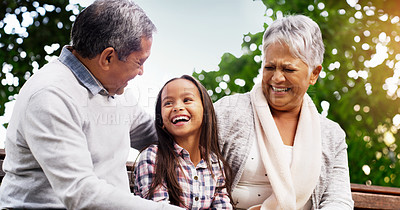 Buy stock photo Park, bench and happy grandparents with girl, smile and bonding on outdoor adventure together. Old man, senior woman and child in backyard with love, laughing and family fun in nature with grandchild