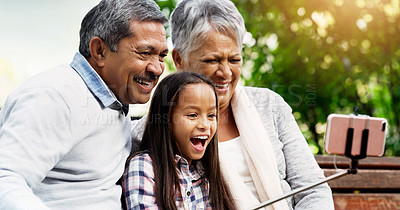 Buy stock photo Laugh, grandparents and young girl take selfie at the park or senior woman or man and excited for picture with kid. Family, child and happy for photo with elderly or spring and bench outside

