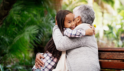 Buy stock photo Happy, young girl and grandmother hug or a flower for senior woman or child with care or bond with pensioner and summer day in the park. Joy, kid and elderly person embrace on the bench with love