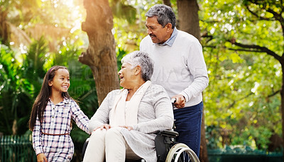 Buy stock photo Grandparents, park and a senior woman in a wheelchair together with her husband and granddaughter. Disability, family or kids and a girl child bonding with her senior relatives in a natural garden