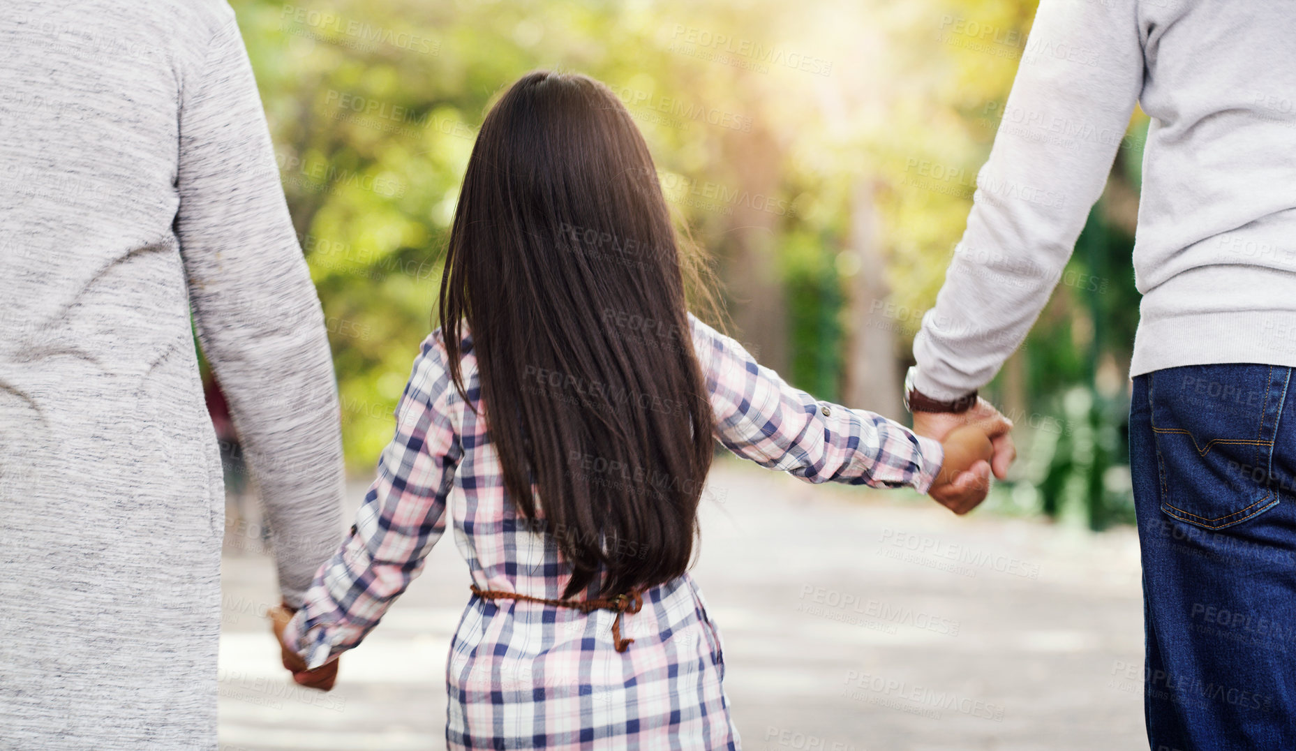 Buy stock photo Back, park and a girl holding hands with her grandparents while walking together in a garden during summer. Nature, family or kids and a female child, grandmother and grandfather bonding outdoor