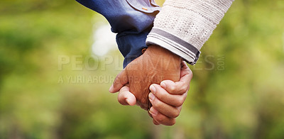 Buy stock photo Closeup, love and couple holding hands, outdoor and relationship with romance, bonding and support. Zoom, partners and man with woman, touching hand and trust with solidarity, marriage and nature