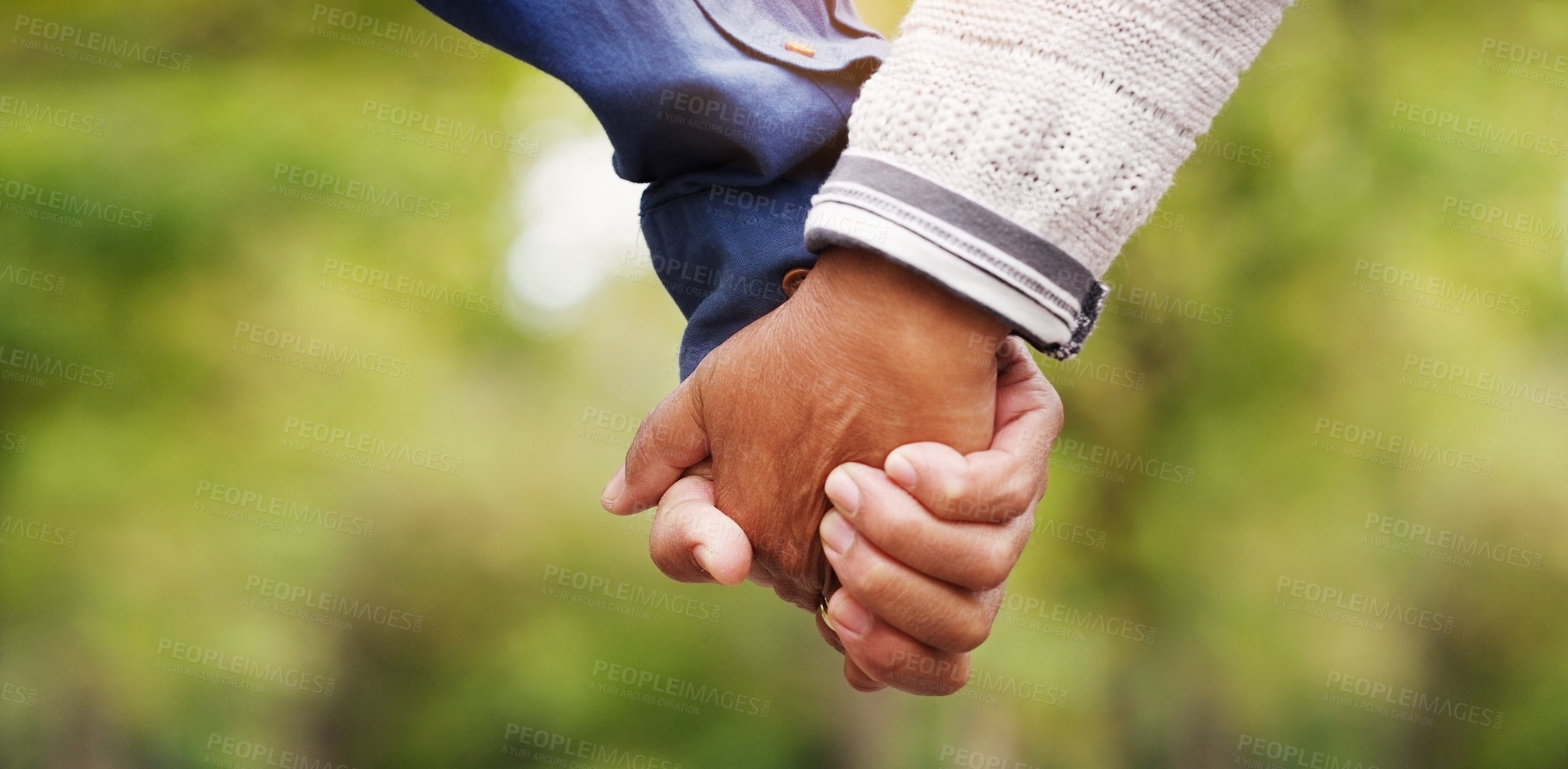 Buy stock photo Closeup, love and couple holding hands, outdoor and relationship with romance, bonding and support. Zoom, partners and man with woman, touching hand and trust with solidarity, marriage and nature