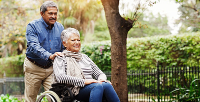 Buy stock photo Elderly man, woman and wheelchair in park by trees with love, care and happy on vacation in summer. Senior people, old couple and person with disability in nature for rehabilitation in retirement