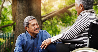 Buy stock photo Senior couple, talk and wheelchair in park by trees with love, connection and smile on vacation in summer. Elderly woman, old man and person with disability in nature for rehabilitation in retirement