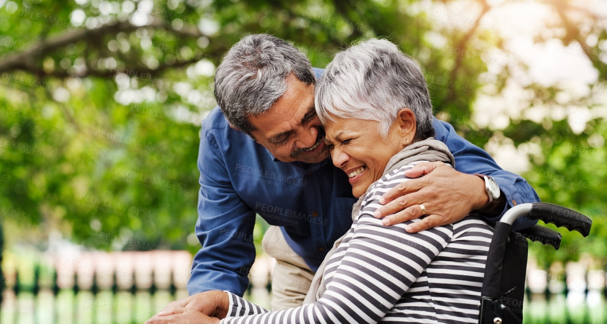 Buy stock photo Senior couple, hug and laugh with wheelchair in park by trees for love, connection or happy on vacation in summer. Elderly woman, old man and person with disability for rehabilitation in retirement