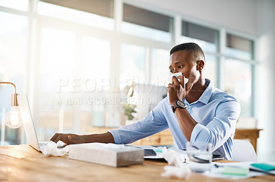 Buy stock photo Shot of a young businessman suffering with a cold while sitting at his  office desk at work