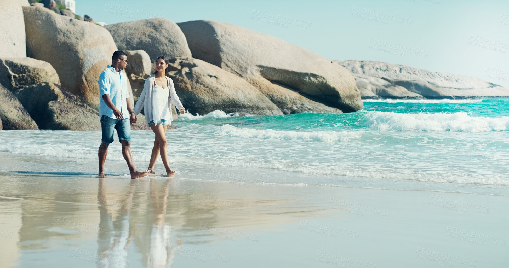 Buy stock photo Ocean, waves and couple walk on beach, honeymoon or anniversary date with holiday in California. Hand holding, connection and trust with support outdoor, respect and loyalty for marriage on the shore