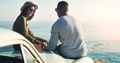 Buy stock photo Cropped shot of a young couple making a stop at the beach while out on a road trip