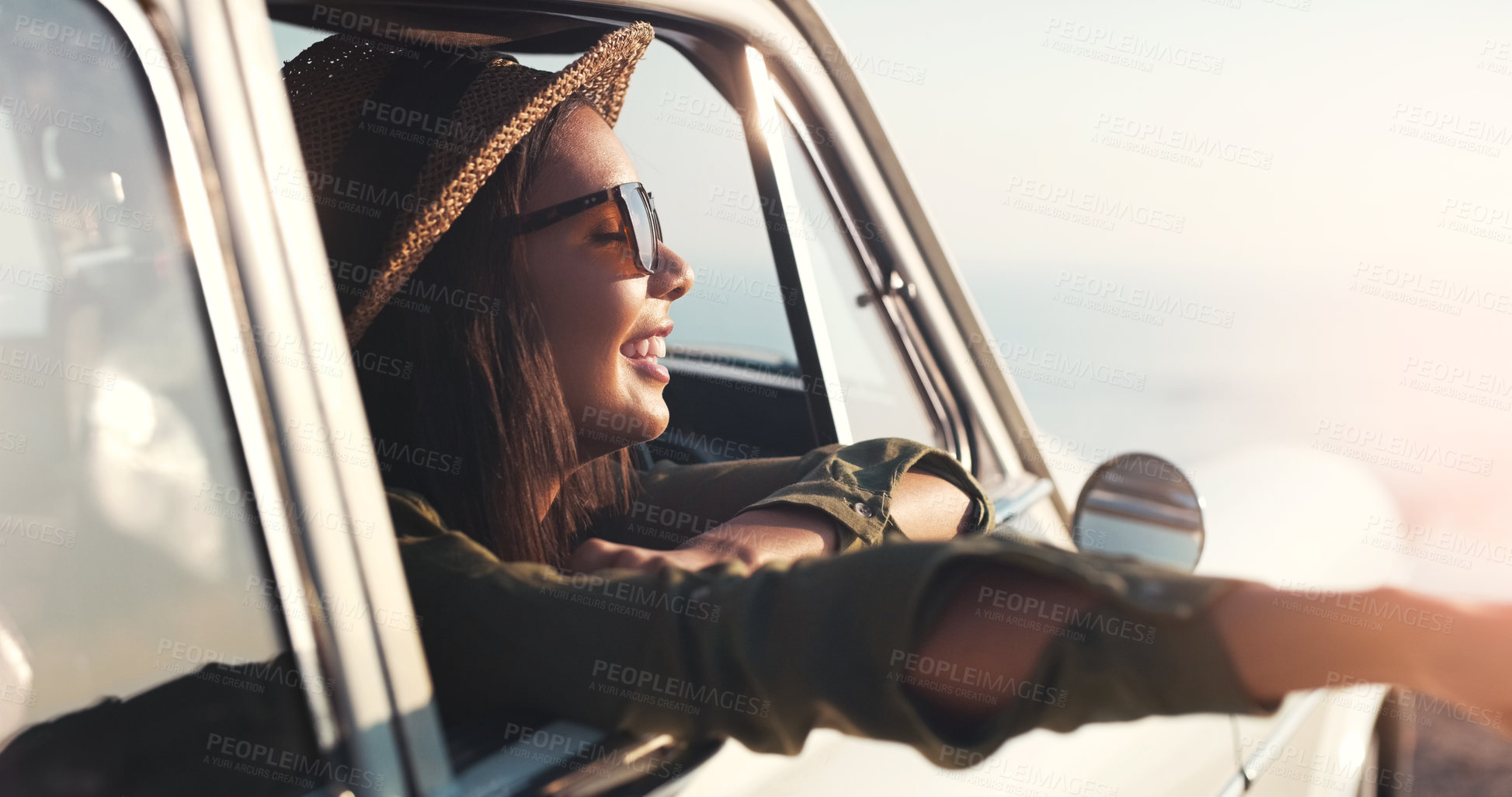 Buy stock photo Road trip, window and happy with a woman in a car for travel, freedom or a joy ride as a tourist on the coast. Nature, sunset and relax with a young female traveler taking a drive for adventure