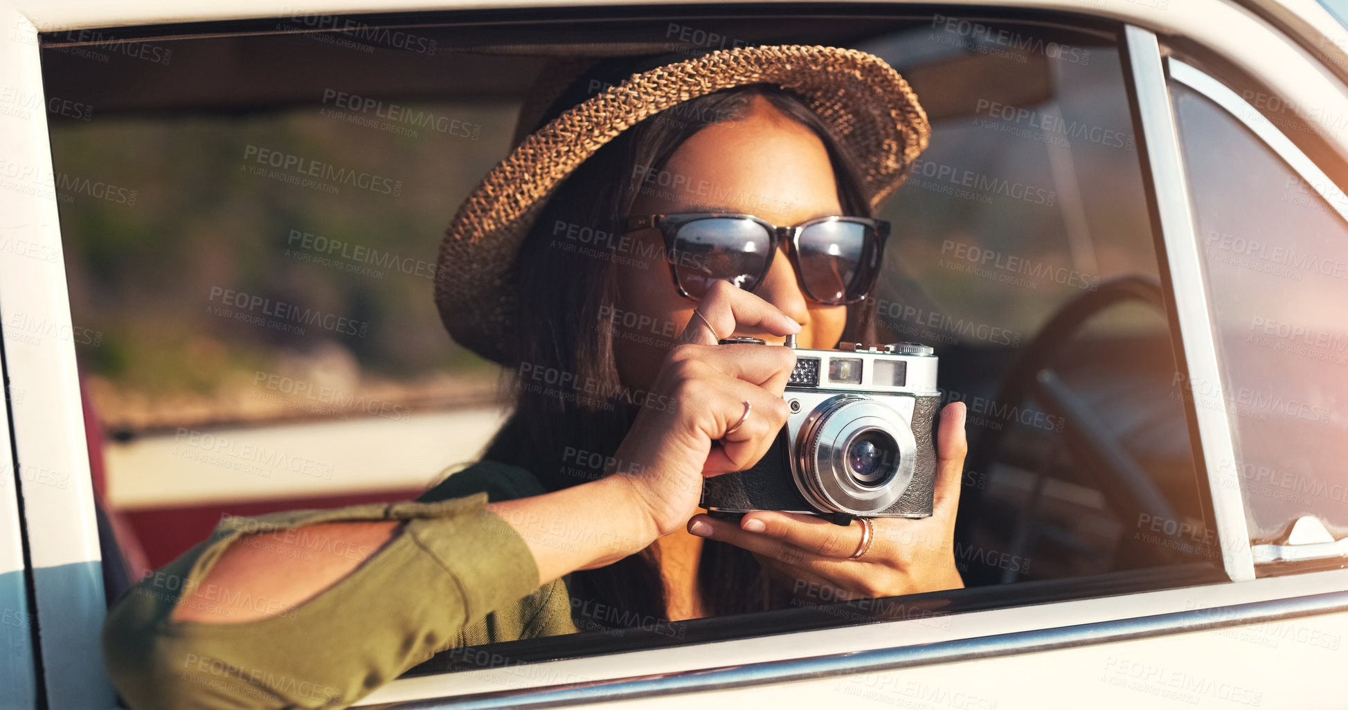 Buy stock photo Cropped shot of an attractive young woman taking photographs while on a road trip