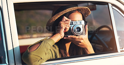 Buy stock photo Cropped shot of a young woman taking photographs while on a road trip