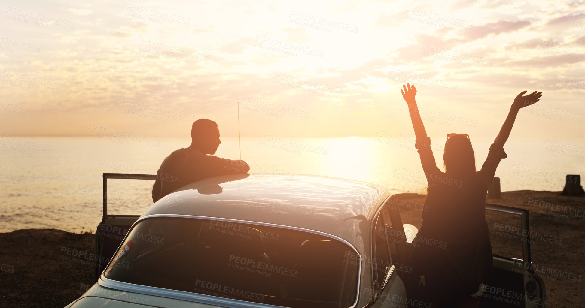 Buy stock photo Cropped shot of a young couple cheering at the beach while out on a road trip