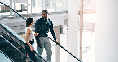 Buy stock photo Business people, escalator and discussion with colleague for work trip, travel or career opportunity at office. Businessman and woman talking on electric staircase or lift in immigration at workplace