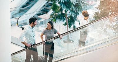 Buy stock photo Escalator, business people and staff talking, discussion and happiness with ideas, planning or chatting. Man, woman or coworkers in a modern office, conversation or communication on a moving stairway
