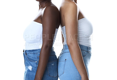 Buy stock photo Portrait of two unrecognizable women standing back to back against a white background
